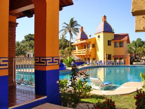 a resort with a swimming pool and a building at Canadian Resort Vallarta in Bucerías