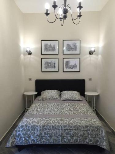 - une chambre avec un lit et trois photos sur le mur dans l'établissement Beautiful apartment Rue De La Croix Vieux Nice, à Nice