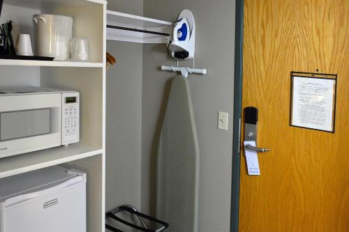 a door to a kitchen with a microwave and a refrigerator at Hilltop Inn by Riversage in Billings
