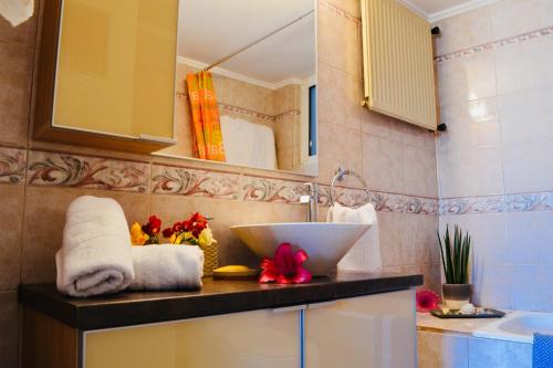 a bathroom with a sink and a counter with towels at Perfect View in Piraeus