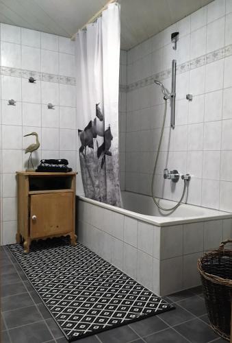 a bathroom with a tub and a shower with a shower curtain at Rüf Stefanie in Au im Bregenzerwald