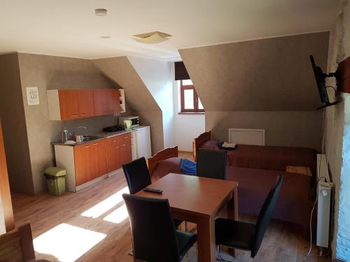 a living room and kitchen with a table and a couch at Märjamaa Hostel in Märjamaa