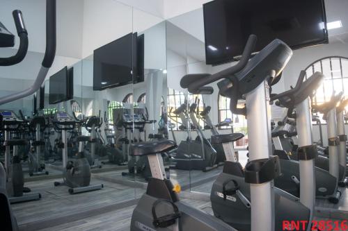 a gym with a bunch of treadmills and mirrors at Hotel Union in Girardot