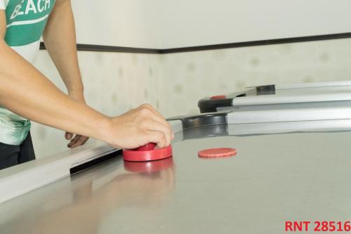 a person holding a red ball on a ping pong table at Hotel Union in Girardot