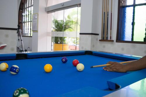 a man playing pool with balls on a pool table at Hotel Union in Girardot