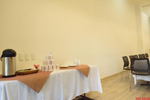 a table with a white table cloth on it at Hotel Union in Girardot
