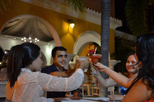 a group of people sitting at a table drinking cocktails at Hotel Union in Girardot