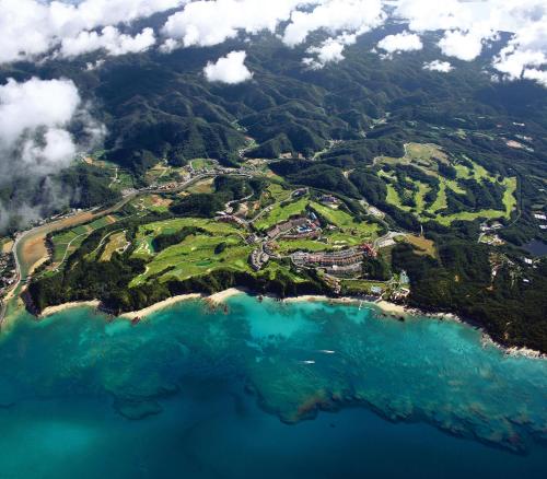 an aerial view of an island in the ocean at Kanucha Bay Hotel & Villas in Nago