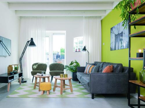 a living room with a couch and a table at 't Veldehof in Domburg