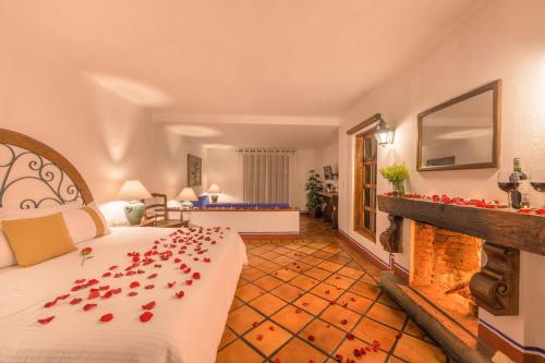 a hotel room with a bed with roses on it at Tapalpa Country Club Hotel in Tapalpa