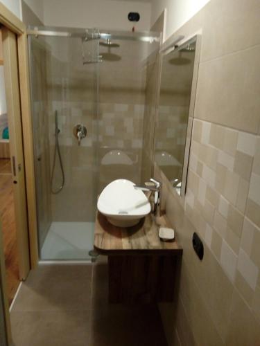a bathroom with a sink and a shower at Appartamento Cristallo di Ghiaccio in Passo del Tonale