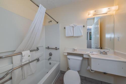 a bathroom with a tub and a toilet and a sink at Tampa Bay Extended Stay Hotel in Largo
