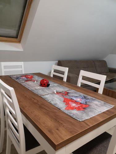 a dining room table with a lady bug on it at Lovac apartmani in Zlatibor