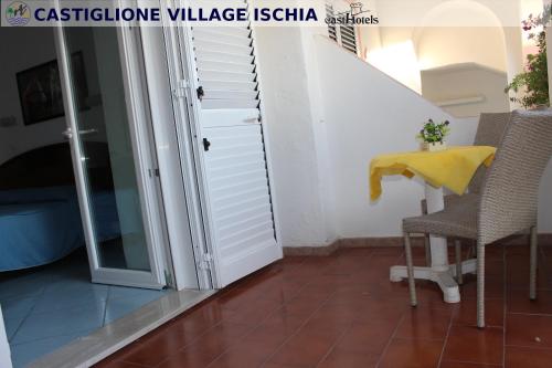 a staircase leading up to a room with a table and chairs at Hotel Castiglione in Ischia