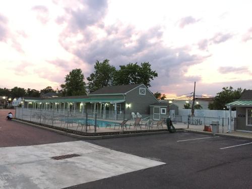 a building with a pool in a parking lot at Sea Girt Lodge in Sea Girt