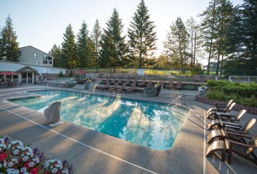 a large swimming pool with chairs at Meadow Lake Resort & Condos in Columbia Falls
