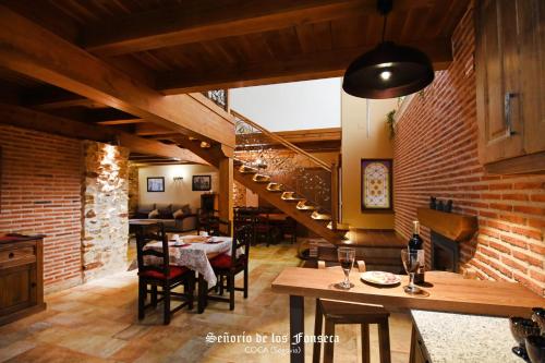a living room with a staircase and a dining room at Señorío de los Fonseca in Coca