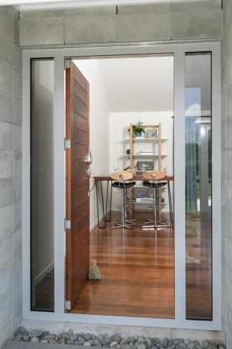 a sliding glass door leading into a dining room with a table at Spacious Modern Two-Bedroom Apartment in Hamilton