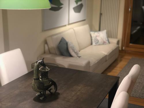 a living room with a table and a couch at Apartamento Mercedes in Logroño