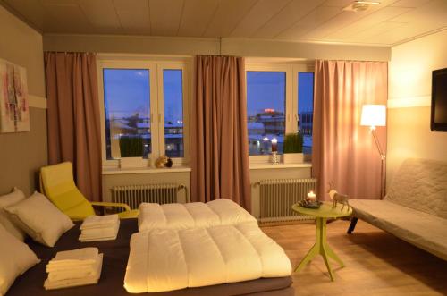 a living room with a white couch and a window at Aurora Motel in Kemi