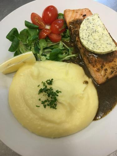 a plate of food with meat and vegetables on it at Penzion Na Solné stezce in Kašperské Hory