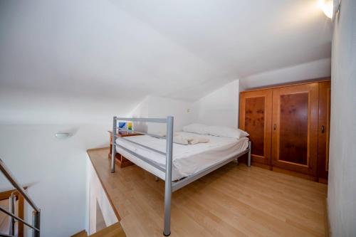 a bedroom with a bunk bed in a room at Apartments Residence Astoria in Rab
