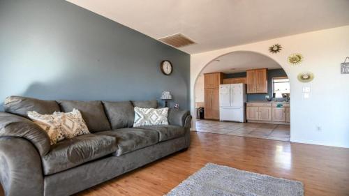 a living room with a couch and a kitchen at Hoodoo House - 4-Bedroom Near Lake Powell in Page