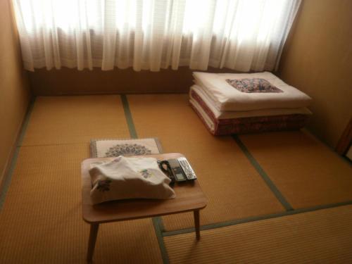 Postel nebo postele na pokoji v ubytování Kakiya Ryokan