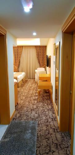 a hotel room with a bedroom and a living room at Muscat Plaza Hotel in Muscat