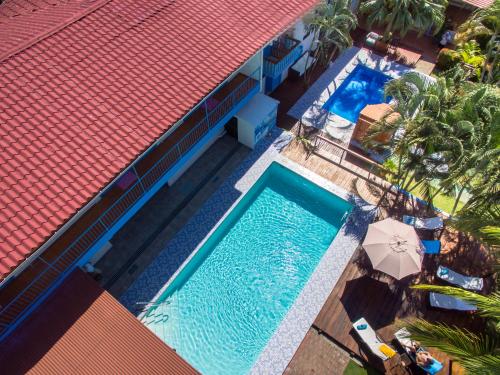 an overhead view of a swimming pool next to a building at Hotel IBIZA Beach Boutique in Jacó