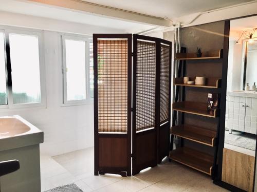 a bathroom with a sink and a wooden closet at New Apartment Nearby Beach in Hua Hin
