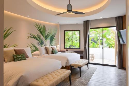 En eller flere senge i et værelse på Tungtong Beach Villas
