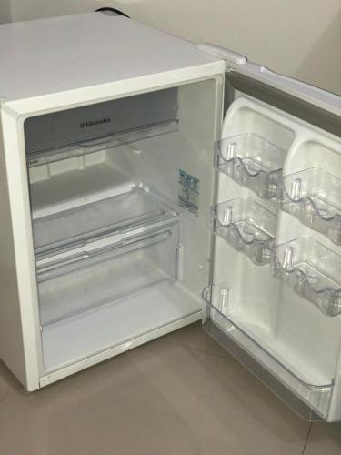 an empty refrigerator with its door open in a kitchen at Hotel Rio Verde in Dianópolis