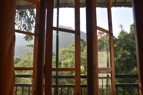 an open window looking out at a mountain view at White Villa Kitulgala in Kitulgala