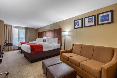 a hotel room with a bed and a couch at Comfort Suites Pelham Hoover I-65 in Pelham