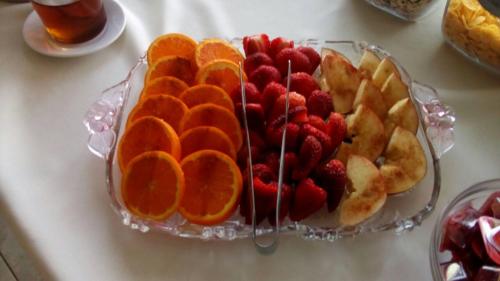 a glass plate with fruit on a table at Anthemis Hotel Apartments in Samos