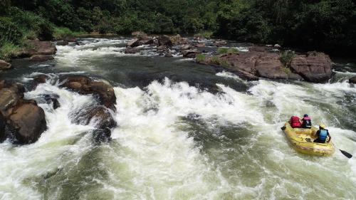 a yellow raft in a river with people on it at White Villa Kitulgala in Kitulgala