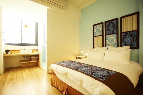 a bedroom with a large bed in a room at Your Fun Apartment in Tainan