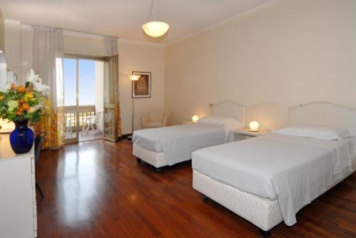 מיטה או מיטות בחדר ב-Residence Hotel Torino Uno