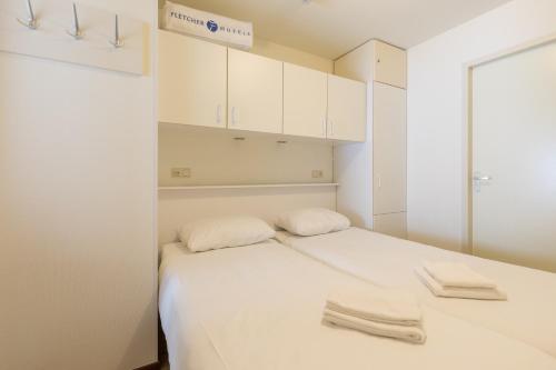 Postel nebo postele na pokoji v ubytování Fletcher Hotel-Restaurant Amelander Kaap