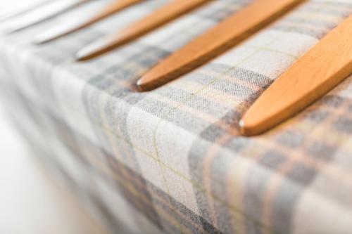 a close up of a plaid table cloth with wooden chopsticks at Das Salvator Iris Porsche Landhotel in Friesach