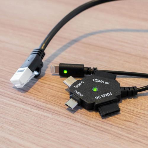 a usb controller with a usb cord on a wooden table at Super Hotel Nagano Iida Inter in Iida