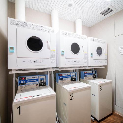 a room with three microwaves on a wall at Super Hotel Nagano Iida Inter in Iida
