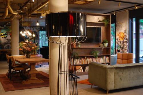 a living room with a couch and a table at Hotel the Match in Eindhoven