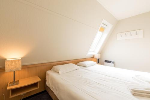 Postel nebo postele na pokoji v ubytování Fletcher Hotel-Restaurant Amelander Kaap