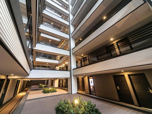 an office building with large windows and a courtyard at APA Hotel Namba-Eki Higashi in Osaka