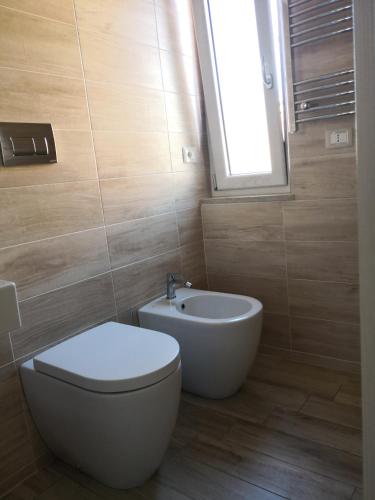 a bathroom with a toilet and a sink at Michelangelo Home B&B in Rossano
