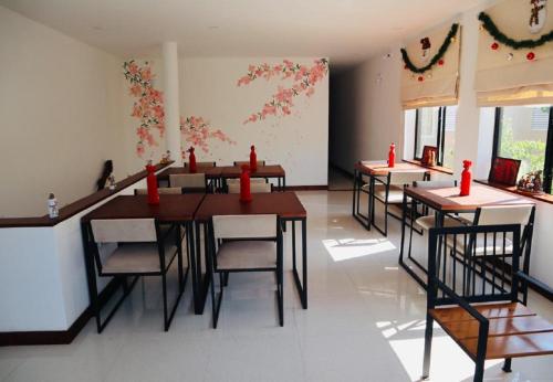 a dining room with tables and chairs with red candles at Visakha 6 in Colombo