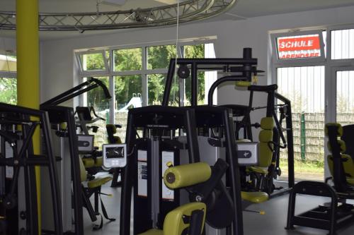 a gym with rows of treadmills and machines at Wellness- & Sporthotel Haus am See in Arendsee
