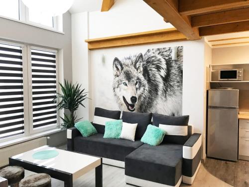 a living room with a wolf painting on the wall at Apartamenty Centrum Rajcza in Rajcza